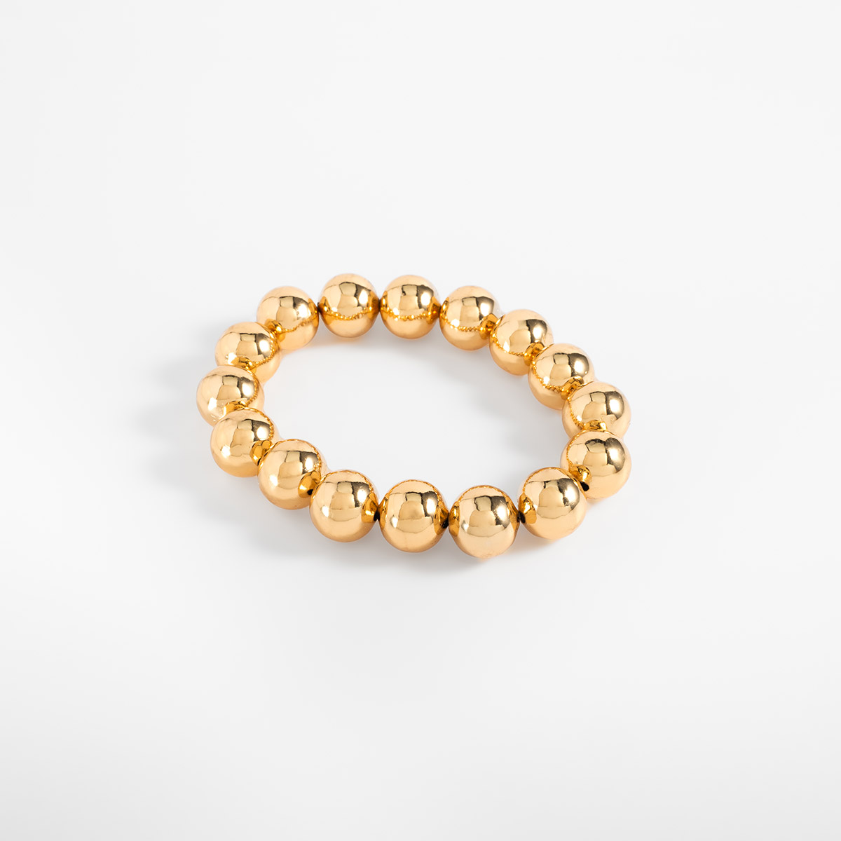 Pulsera en baño de oro esferas grandes diseño elástico